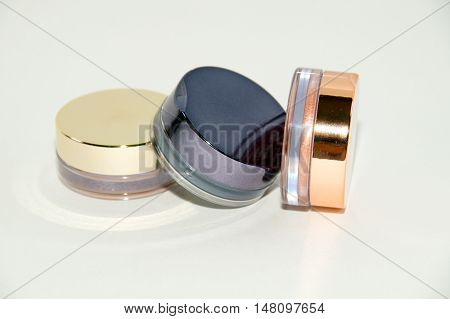 Three yeshadow glass boxes on white background with soft shadows and reflections .