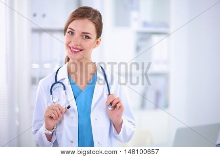 Portrait of happy successful young female doctor holding a stet