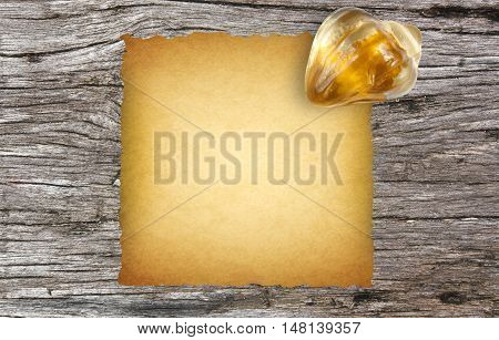 old paper with paperweight on ancient wooden desk background