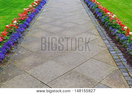 footpath from conrete paver zoned by a flower border