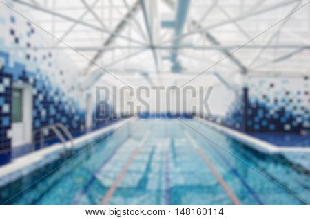 Blurry view of a indoors light swimming pool.
