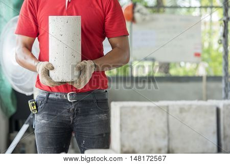 Technician checking of concrete quality during cube demolition