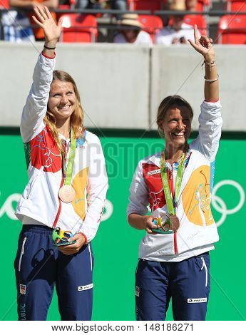 RIO DE JANEIRO, BRAZIL - AUGUST 14, 2016: Bronze medalists team Czech Lucie Safarova (L) and Barbora Strycova during medal ceremony after tennis women's doubles final of the Rio 2016 Olympic Games