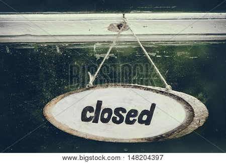 Wooden Sign closed on the old door