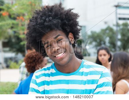 Laughing african man with multiracial outdoor in the city in the summer