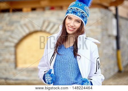 winter, leisure, sport and people concept - happy young woman in ski cothes outdoors