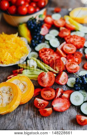 Tomato on wooden table. Freshly Picked red Tomatoes. Variation of tomatoes on wooden surface. Vegetables in the section. Harvesting. Healthy food from the garden.