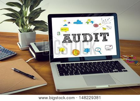 AUDIT Laptop on table. Warm tone businessman working