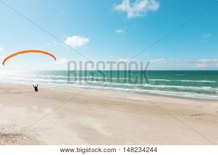 Paragliding on the deserted beach, unspoiled nature