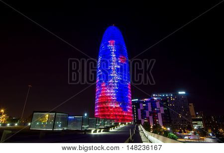 BARCELONA, SPAIN - SEPTEMBER 20, 2014: Night view of the in Barcelona, Spain. 38 story skyscraper built in 2005 by Nouvel. Now one of the symbols of Barcelona is owned by Grupo Agbar.