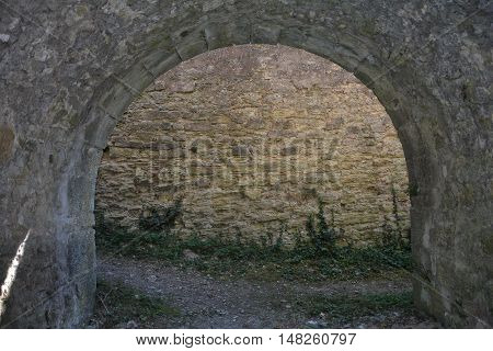Ancient stone arch of a castle  overlooking wall