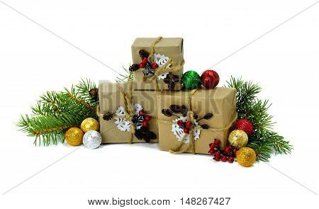 Heap of gift boxes under the Christmas tree branches. Children decorate gifts for their relative. Christmas composition: Gifts Christmas tree branches spheres cones and red berries. / Isolation on a white background /.