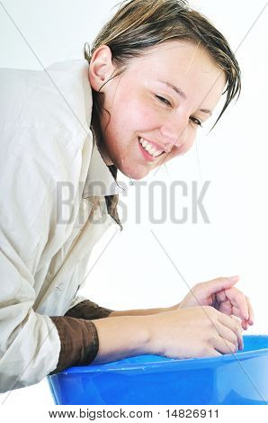 bautiful young woman wash face with clean water isolated on white in studio