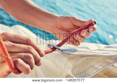 User knitting knots. Bowline knot. Process of tying Bowline process is a top view on the sail.