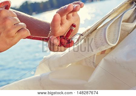 User knitting knots. Bowline knot. Process of tying Bowline process is a top view on the sail.