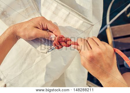 User knitting knots. Bowline knot. Process of tying Bowline process is a top view on the sail.