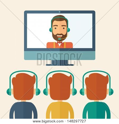 A happy Caucasian businessman in a monitor with beard giving a business presentation with three men infront of him wearing their headphones to hear the voice of the presentor. Business presentation