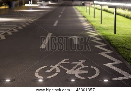 The bicycle sign on the grey road in the public park for biking