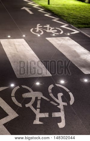 The bicycle sign on the grey road in the public park for biking