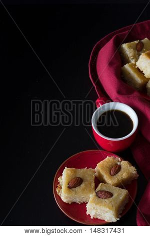 Basbousa and Coffee with Dark Background Vertical with Copy Space from Above