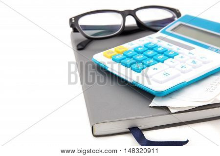 Receipt or bill from shop on gray calculator