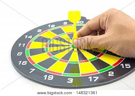 Setting goal or accurate planning hand going to take dart into the center of dartboard