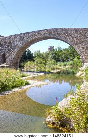 Bridge In Lagrasse With The Abbey Behind And The Reflection In The River