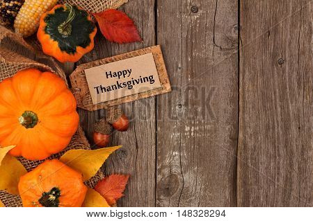 Happy Thanksgiving Gift Tag With Side Border Of Colorful Leaves And Pumpkins Over A Rustic Wood Back
