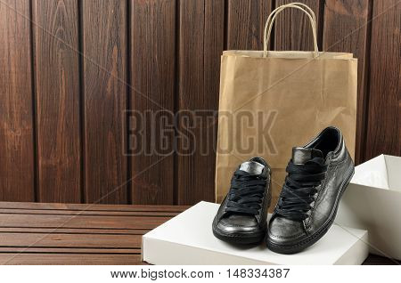 Leather Upper Metallic Trandy Womens Shoes On Brown Wooden Background. Shopping Purchases