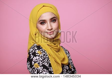 muslimah model in fashionable dress isolated in pink background
