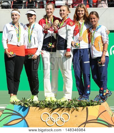 RIO DE JANEIRO, BRAZIL - AUGUST 14, 2016:Tennis women's doubles medalists team Switzerland (L), team Russia and team Czech during medal ceremony of the Rio 2016 Olympic Games at Olympics Tennis Centre