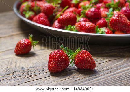 Fresh strawberry on wooden background, autumn crop