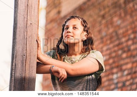 Portrait of beautiful attractive young sad woman has reflected on life at summer green park