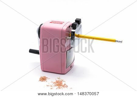Pencil sharpener Sharpening pencil and wood shavings on a white background .