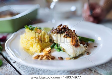 Zander fish fillet dish on a plate on a white wooden table