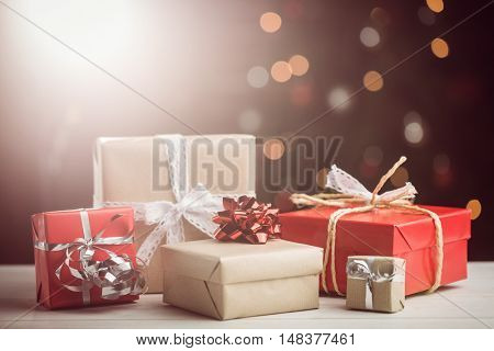 Composite image of presents on table against lightened background
