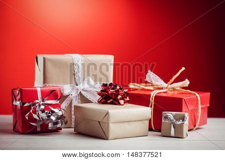 Composite image of presents on a table in red background