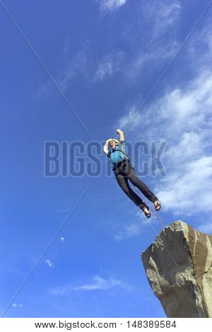 The first jump off the cliff with a safety rope.