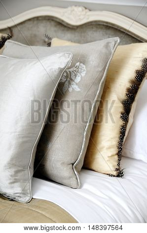 three cushions on a bed in a house