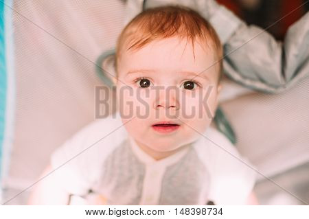 Cute Little Baby Boy Playing In Colorful Playpen, Indoors. Beautiful Child Having Fun At Nursery.