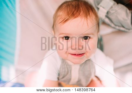 Cute Little Baby Boy Playing In Colorful Playpen, Indoors. Beautiful Child Having Fun At Nursery.