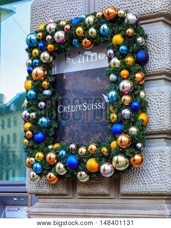 Zurich, Switzerland - 26 December, 2015: stone plate on the wall of the Credit Suisse building on Paradeplatz square with Christmas decorations. Credit Suisse Group is a Swiss multinational financial services holding company, headquartered in Zurich.