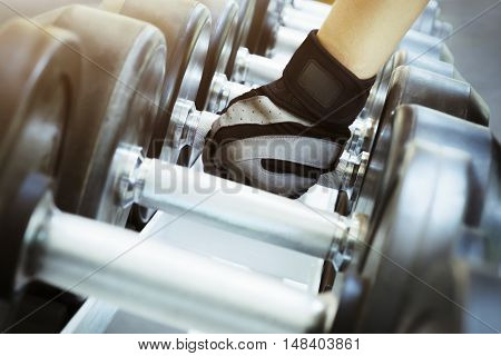 Hand Holding The Dumbells In The Gym.