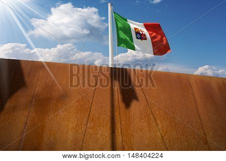 Italian flag with emblem of the four Maritime Republics Venice Genoa Pisa and Amalfi hanging on a ship's mast on blue sky with clouds and sun rays
