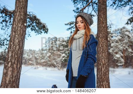 beautiful young woman relaxing on winter walk in snowy forest candid capture lifestyle scene