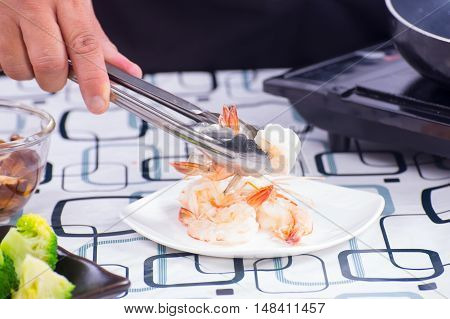 Chef lift cookng shrimp to plate / Stir fry Broccoli concept