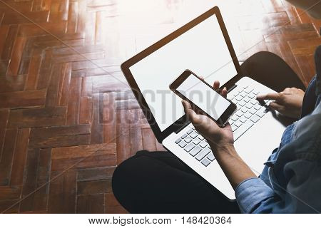 Asia woman use mobile phone and computer laptop. Vintage tone Retro filter effect Soft focus Low light.(selective focus)
