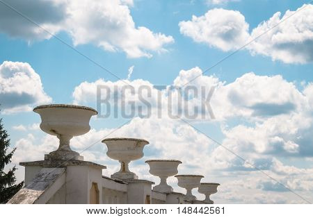 Sculpture on a background of blue sky with large white clouds