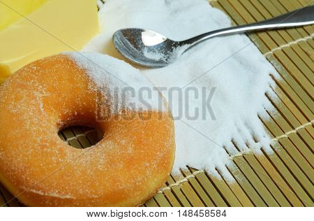 donut with a lot of sugar on bamboo mat