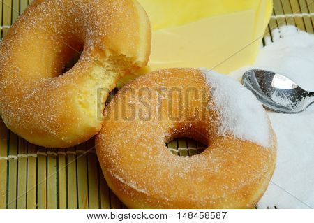 sweet donut with sugar and butter on bamboo mat